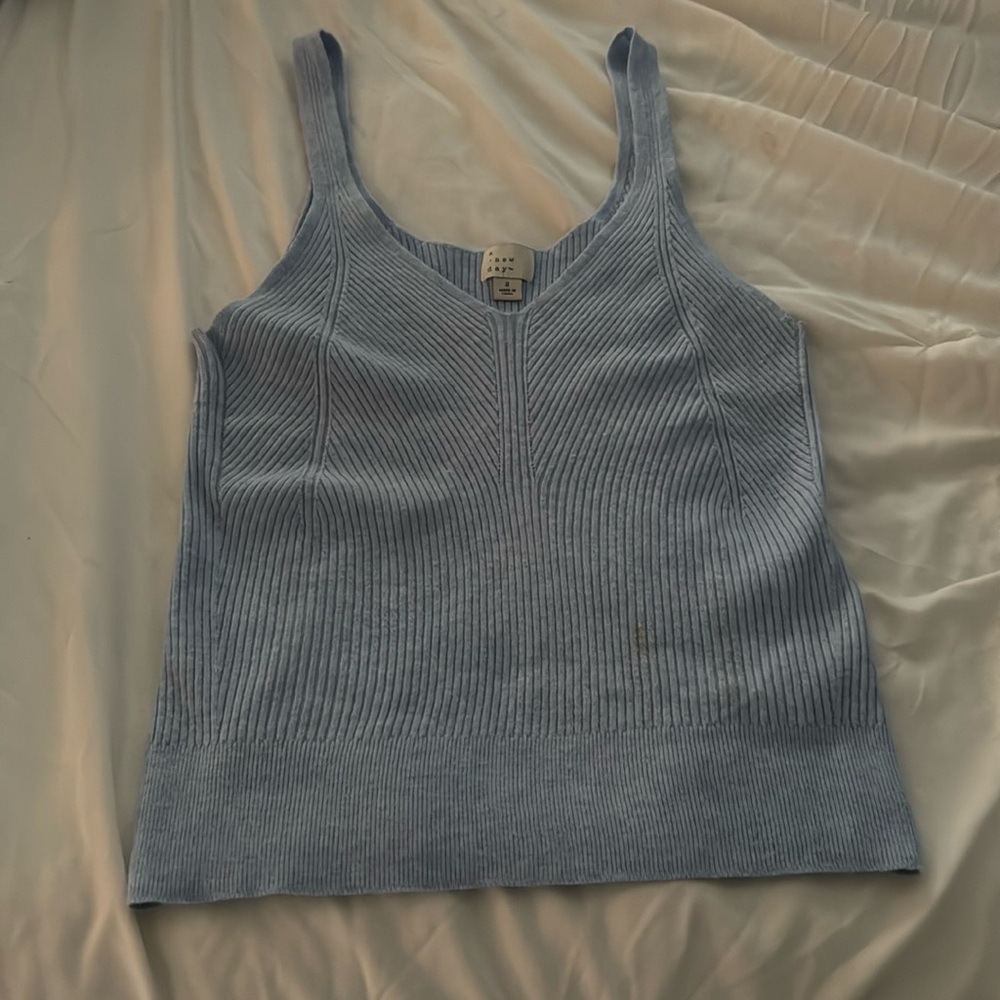 Soft strechab baby blue tank top with line designs on the mid front part